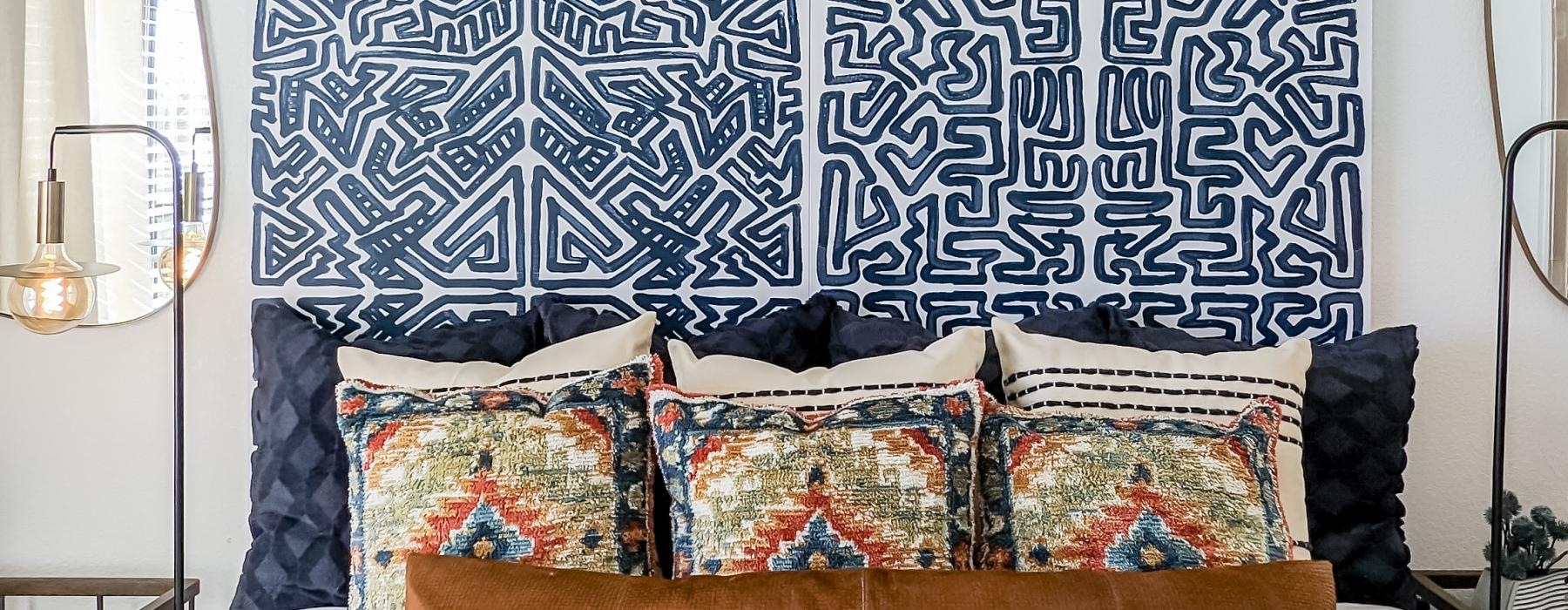 a bed with a large wall of patterned fabric